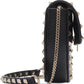 Black studded handbag with gold chain strap on a white background
