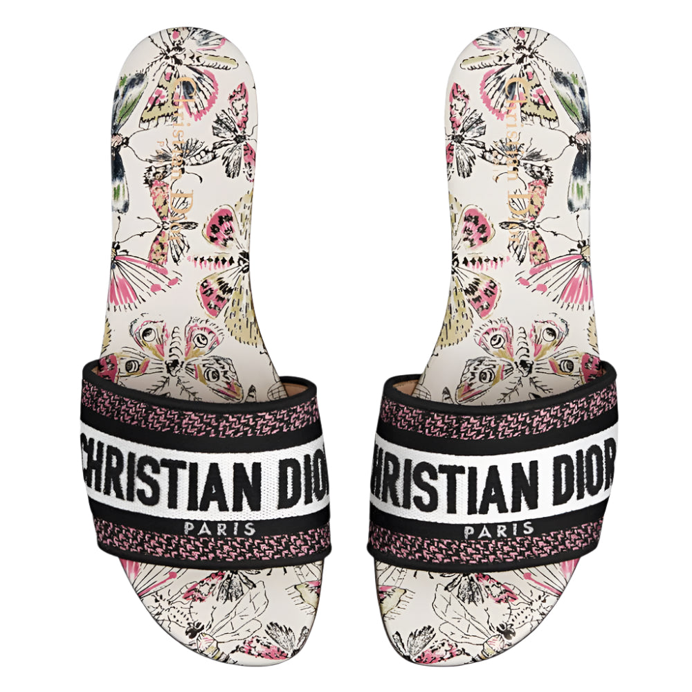 Pair of Christian Dior slides with butterfly pattern on a white background