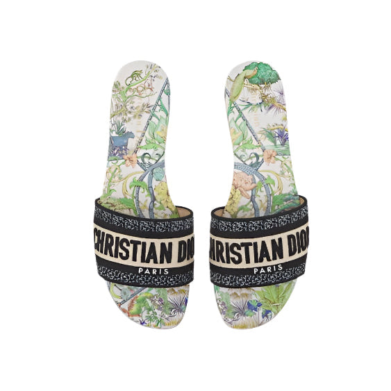 Pair of Christian Dior slides with floral pattern on a white background
