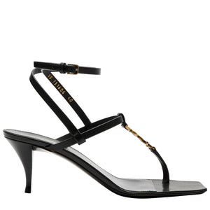 Black high-heeled sandal with thin straps on a white background
