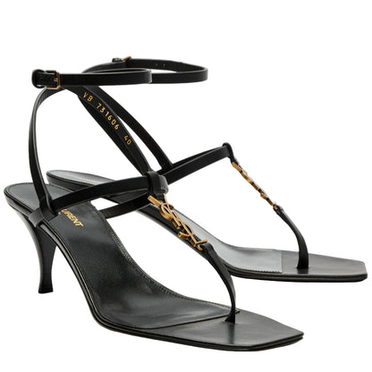 Black high-heeled sandals with thin straps on a white background