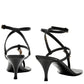 Black high-heeled sandals with thin straps on a white background