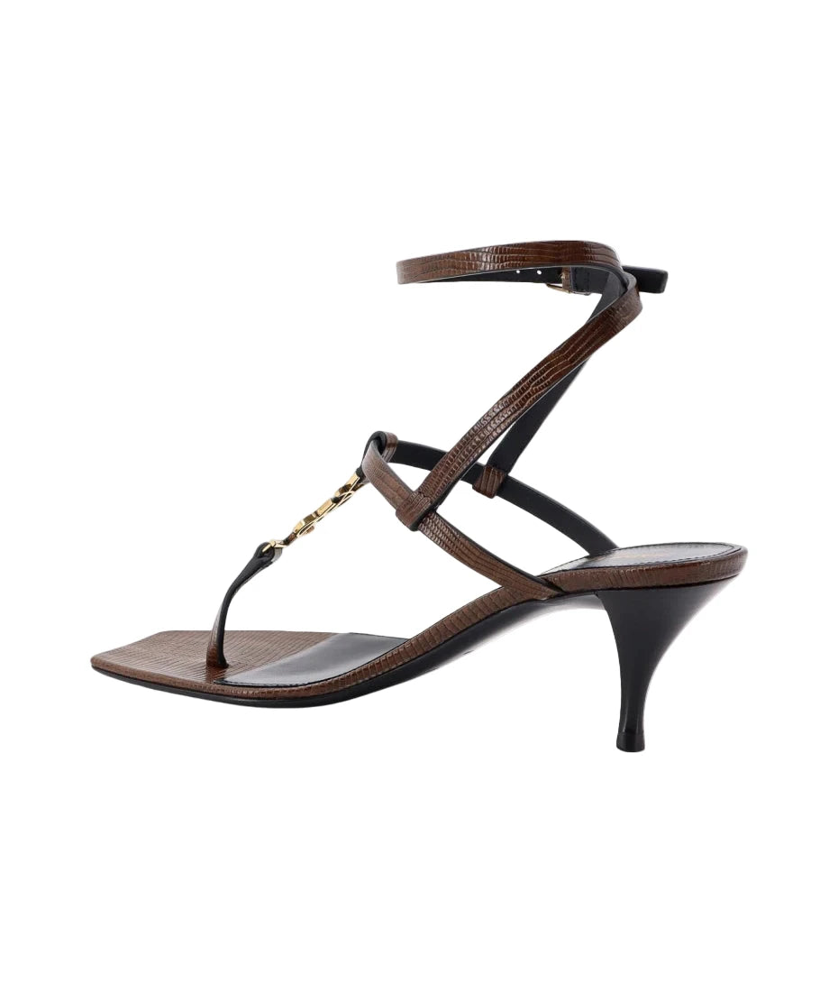 Brown sandal with thin straps on a white background