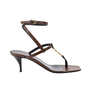 Brown sandal with thin straps on a white background