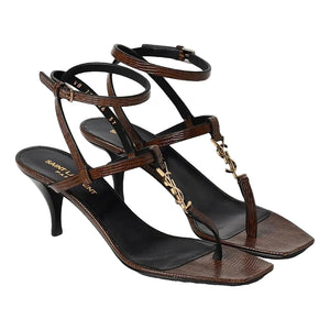 Brown high-heeled sandals with thin straps on a white background