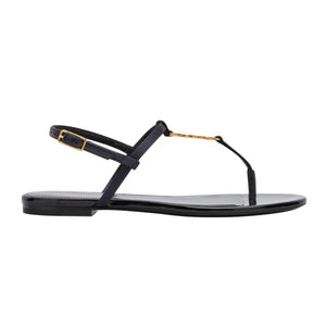 Black sandal with gold accents on a white background