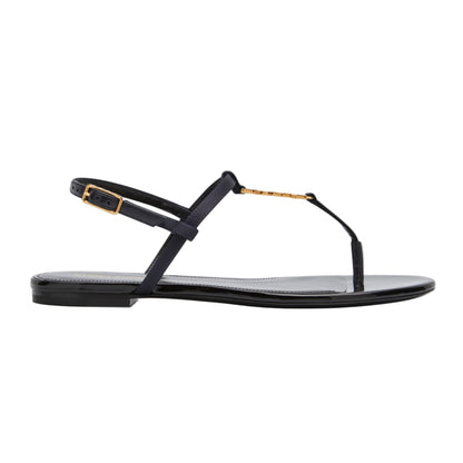 Black sandal with gold accents on a white background