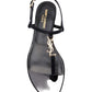 Black sandal with gold logo on a white background