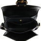 Black leather handbag with gold hardware on a white background