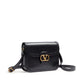 Black handbag with a gold clasp on a white background