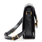 Black handbag with gold accents on a white background