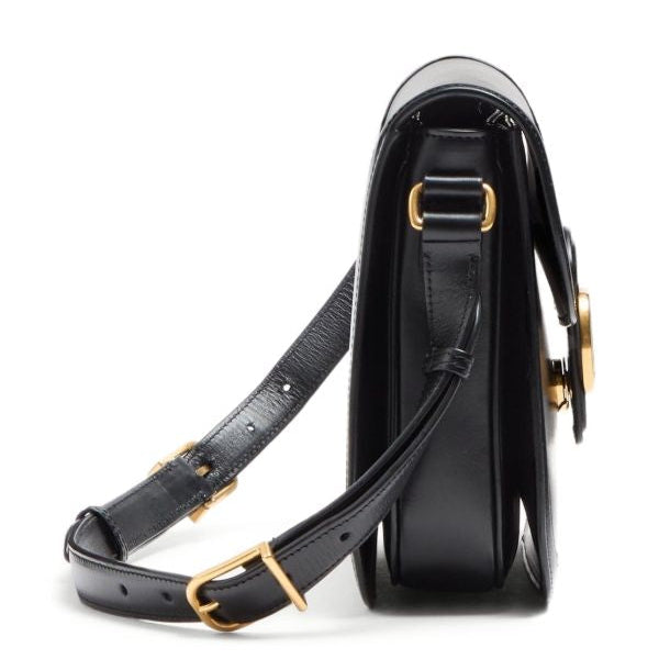 Black handbag with gold accents on a white background