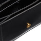 Close-up of a black leather wallet with a gold button on a white background