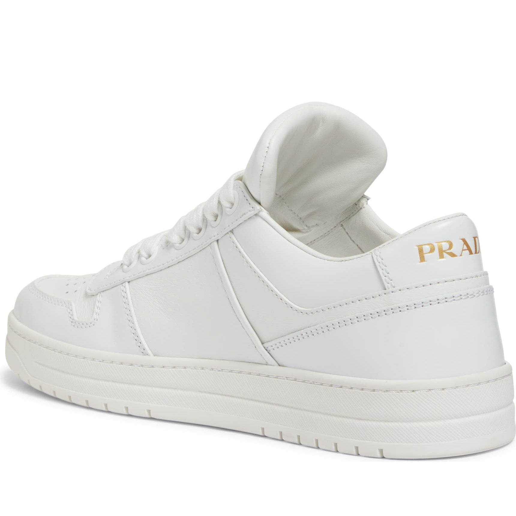 White sneaker with gold logo on a white background
