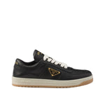 Black sneaker with a brand logo on a light gray background