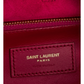 Close-up of a red Saint Laurent bag with gold zipper.