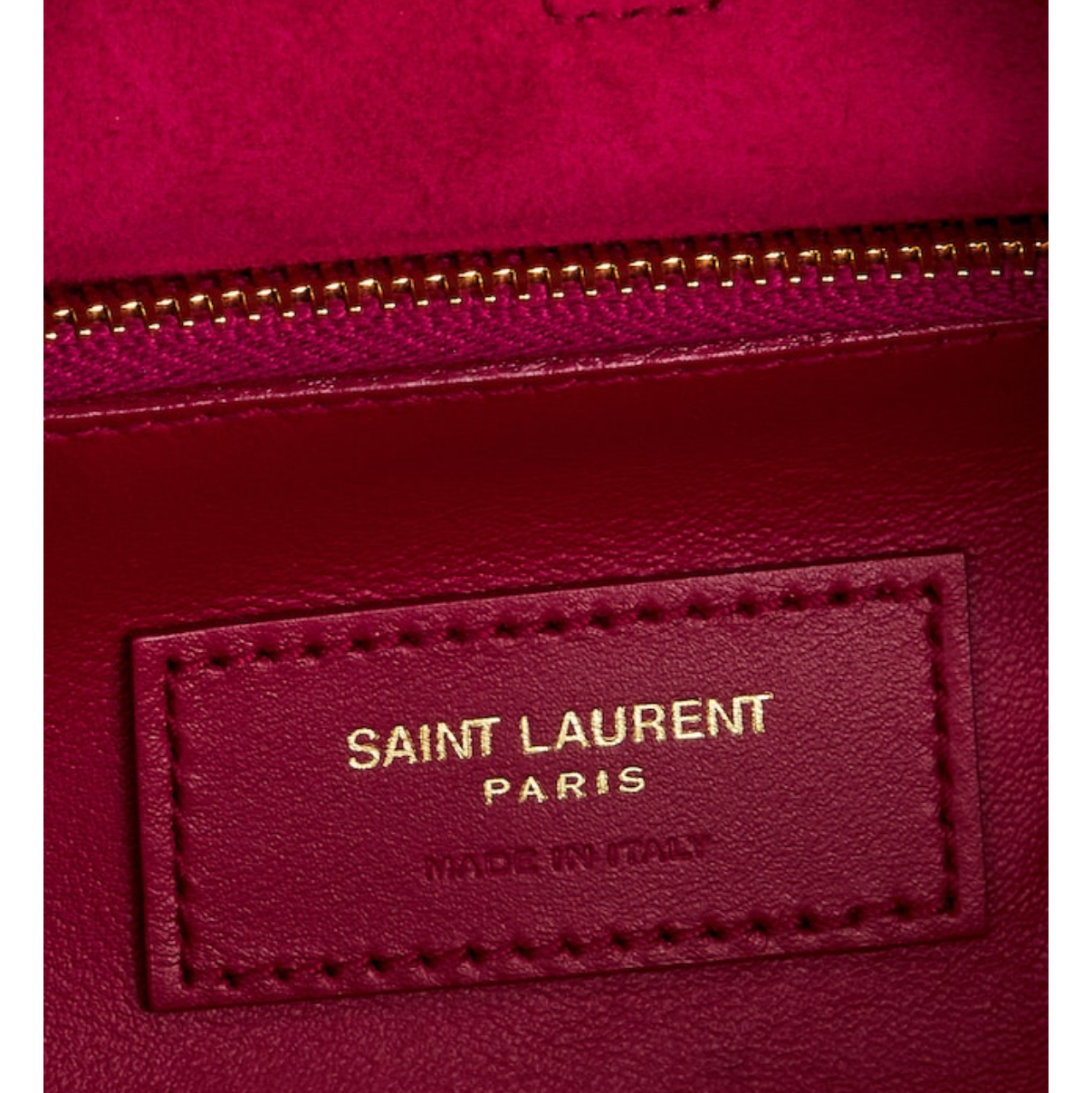 Close-up of a red Saint Laurent bag with gold zipper.