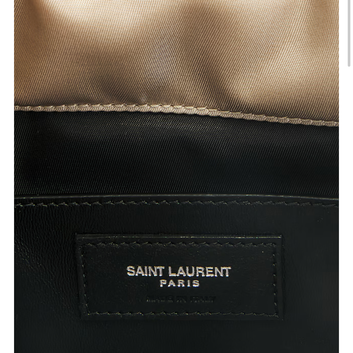 Close-up of a Saint Laurent bag with a beige top and black bottom section.