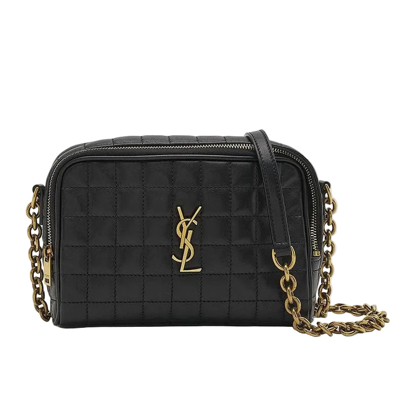 Black quilted handbag with gold chain strap on a light gray background
