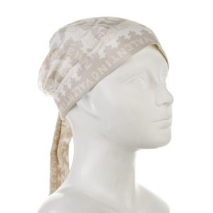 Beige headscarf with ear flaps on a mannequin head against a white background
