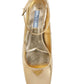 Gold high-heeled shoe with Prada logo on a white background