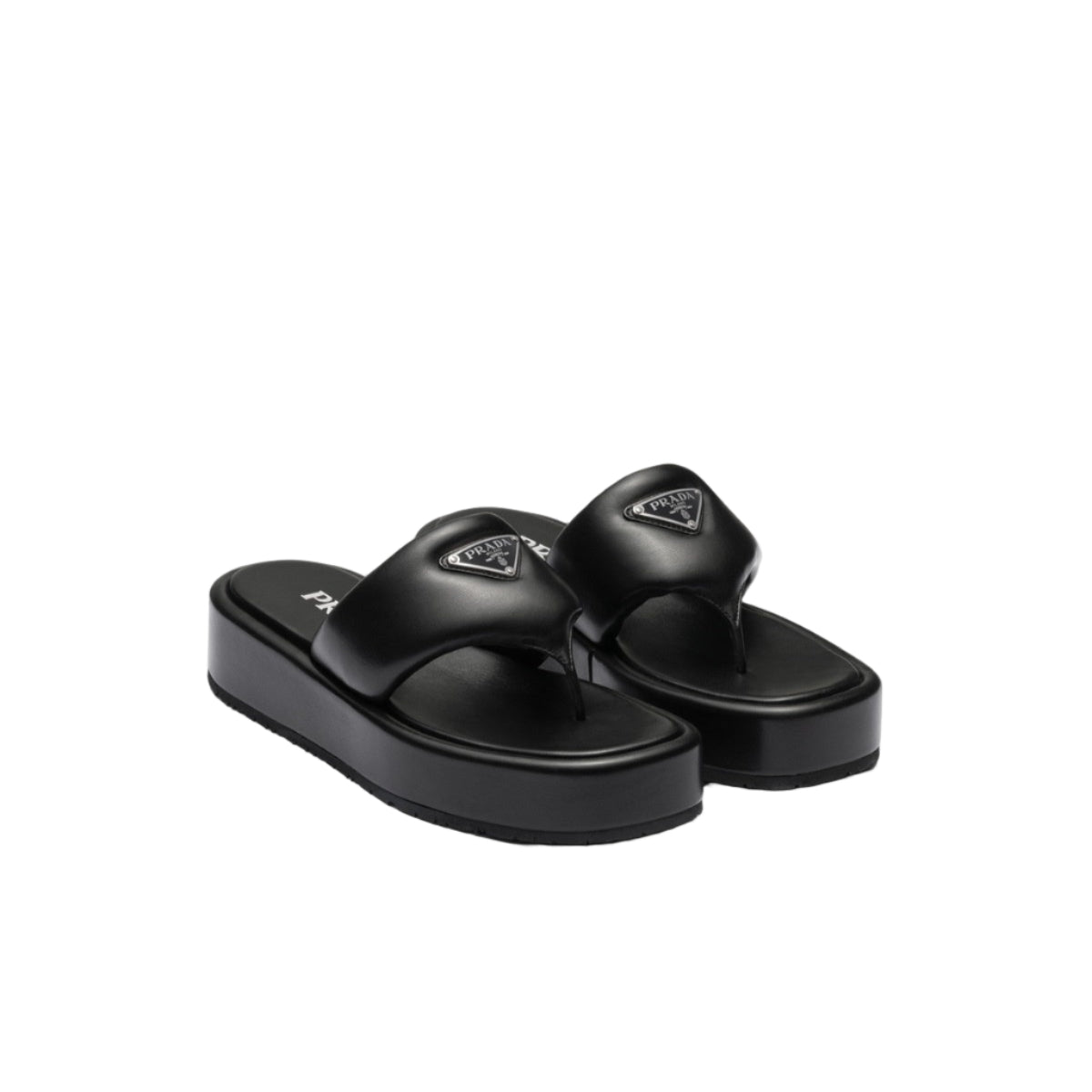 Black sandals with a brand logo on a light gray background