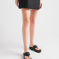 Person wearing black sandals on a white background
