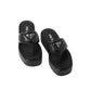 Pair of black Prada sandals on a light gray background