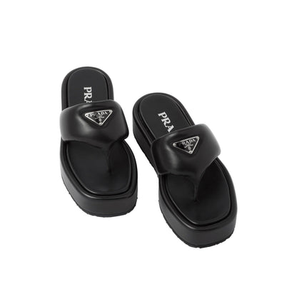 Pair of black Prada sandals on a light gray background