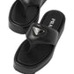 Black Prada sandals on a white background