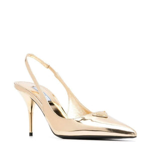 Gold high-heeled slingback shoe on a white background