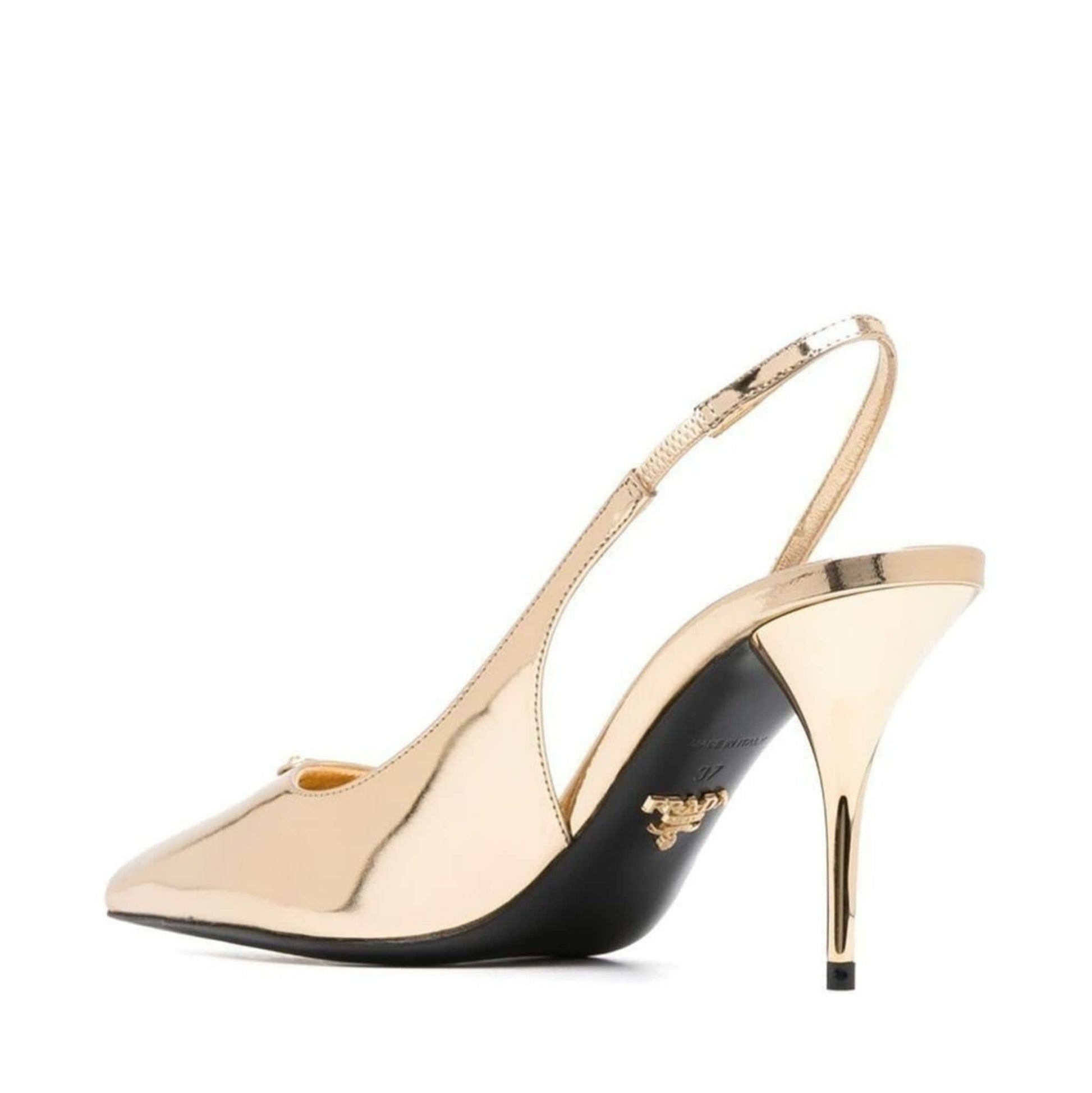 High-heeled shoe with gold and black design on a white background