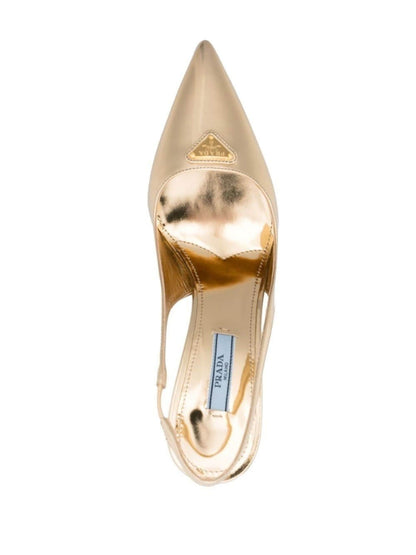 Gold high-heeled shoe with Prada logo on a white background