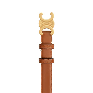 Brown leather belt with gold buckle on a light gray background