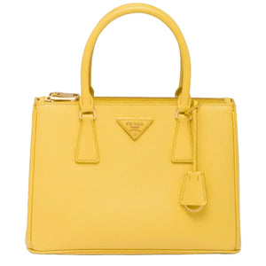 Yellow handbag with Prada logo on a white background