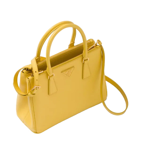 Yellow handbag with a strap on a white background