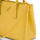 Yellow handbag with Prada logo on a white background