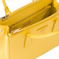 Yellow handbag with gold accents on a white background