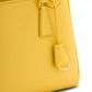 Yellow handbag with a strap on a white background
