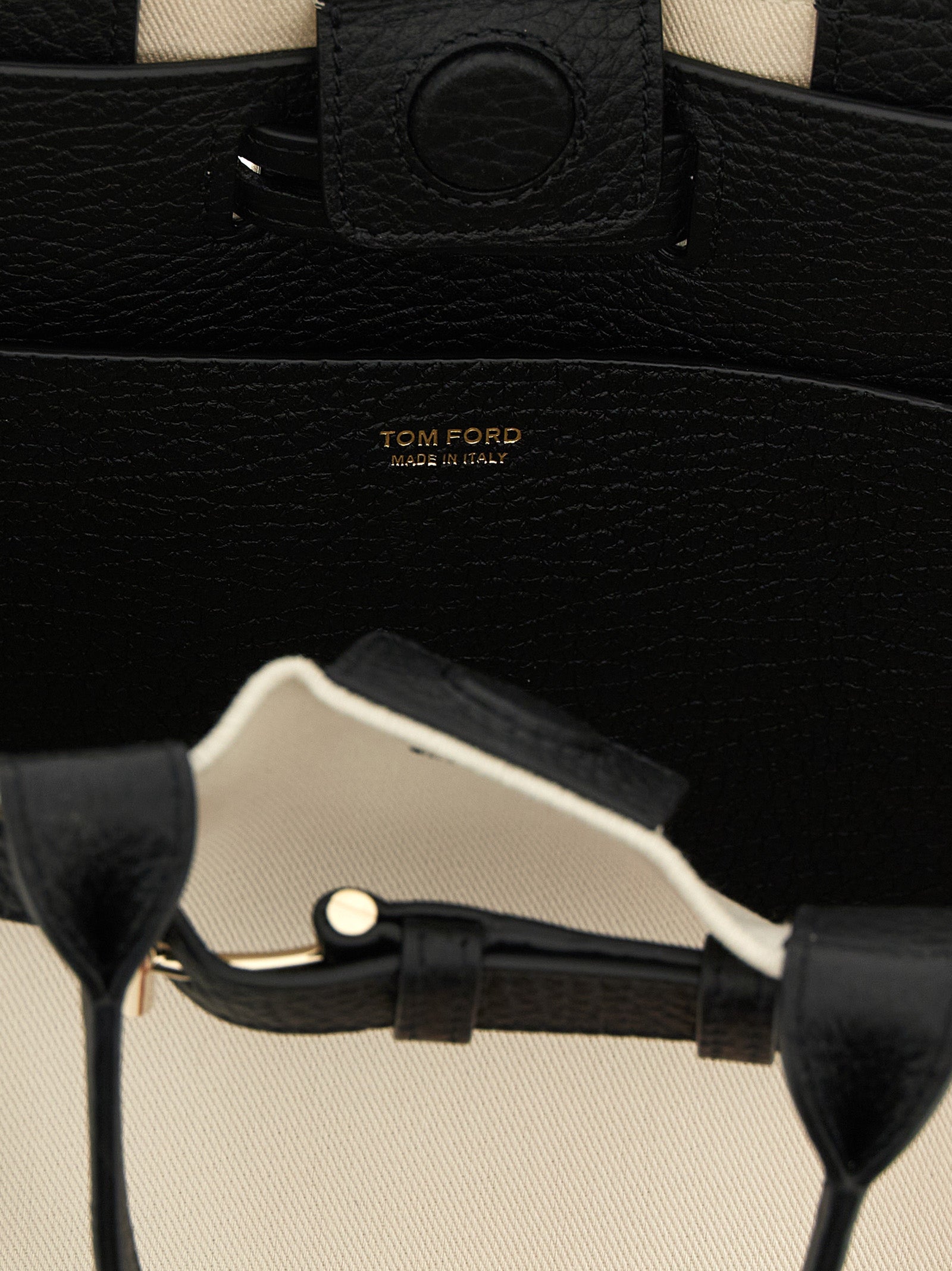 Tom Ford Small Audrey Shopping Bag interior close-up in black hammered leather and canvas with metal T-buckle strap and gold logo