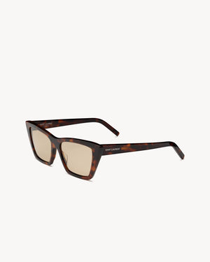 Sunglasses with tortoiseshell frame and beige lenses on a white background