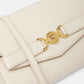 Beige handbag with gold clasp on a white background