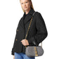 Woman holding a gray handbag with a white background