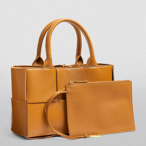 Brown handbag with matching pouch on a light gray background