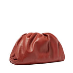 Red leather clutch bag on a white background