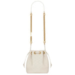 White handbag with gold chain strap on a white background