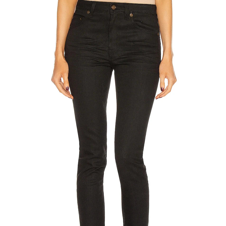 Black jeans worn by a person on a white background