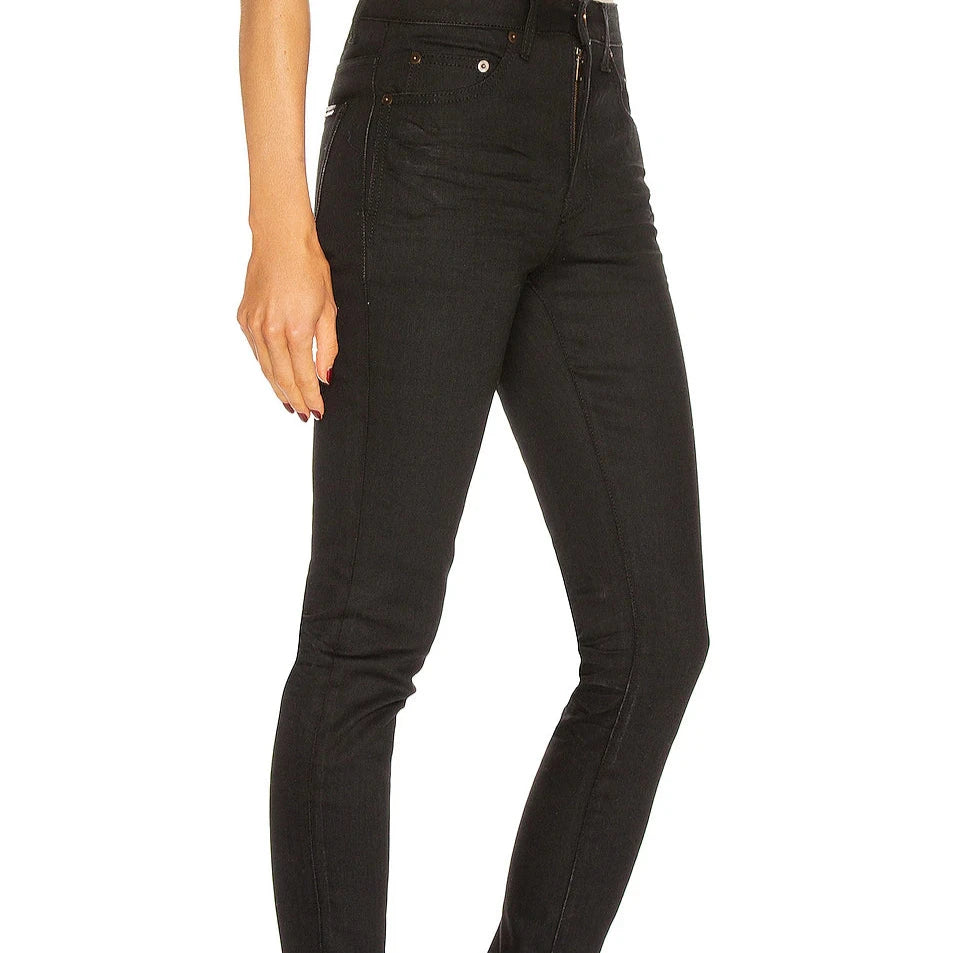 Black jeans worn by a person on a white background