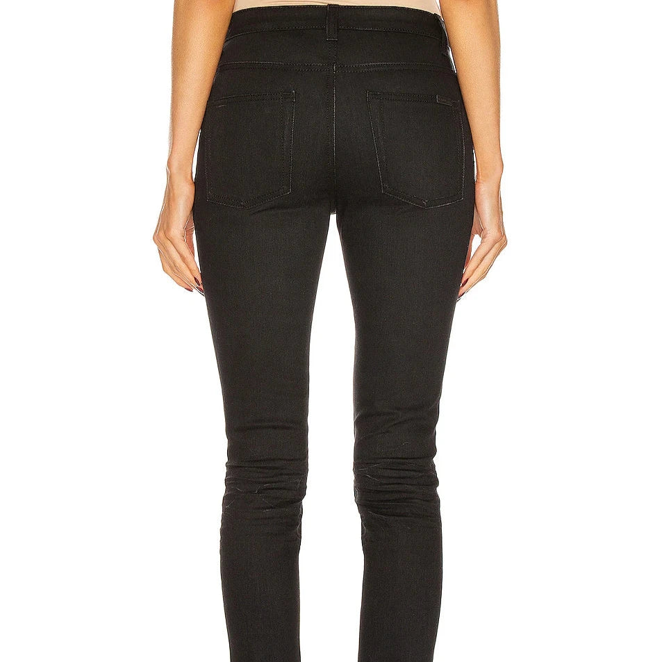 Black jeans worn by a person on a white background