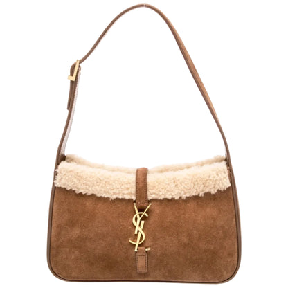 Brown handbag with shearling trim and Yves Saint Laurent logo on a white background